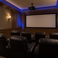 A home theater with a projector and a large screen.