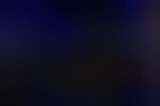 A dark blue background with a few white spots on it