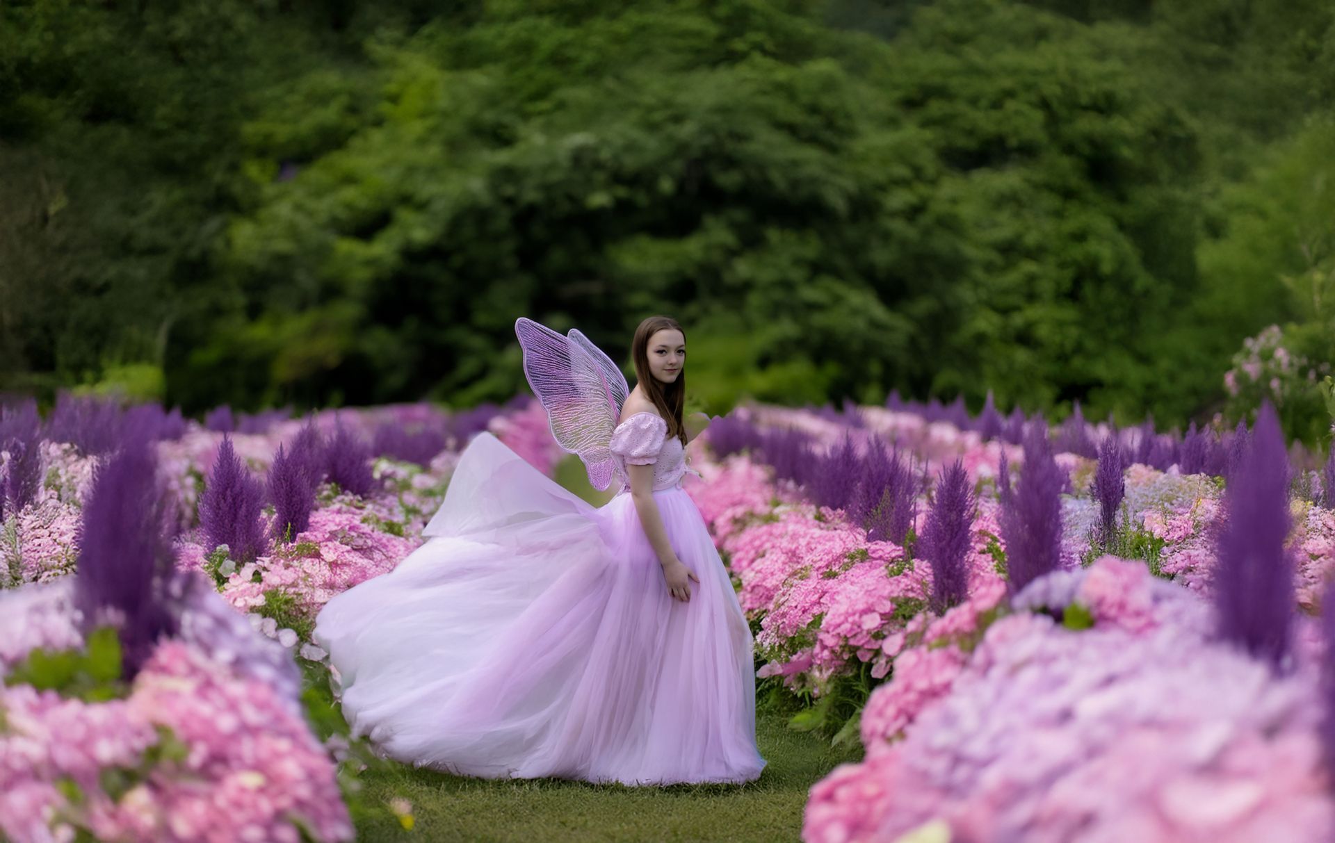A woman in a purple dress is standing in a field of purple flowers.