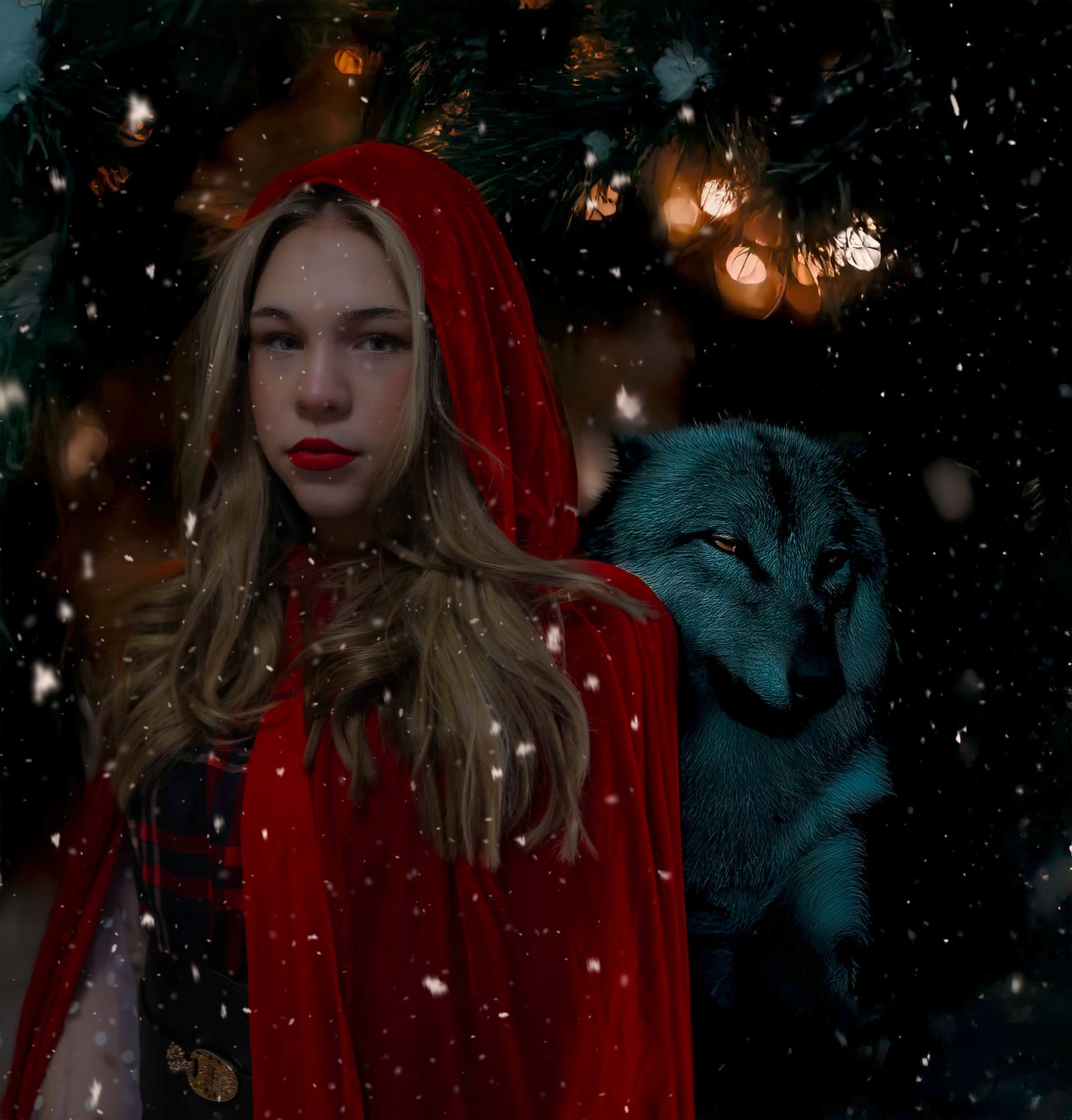 A woman in a red cape is standing next to a wolf in the snow.