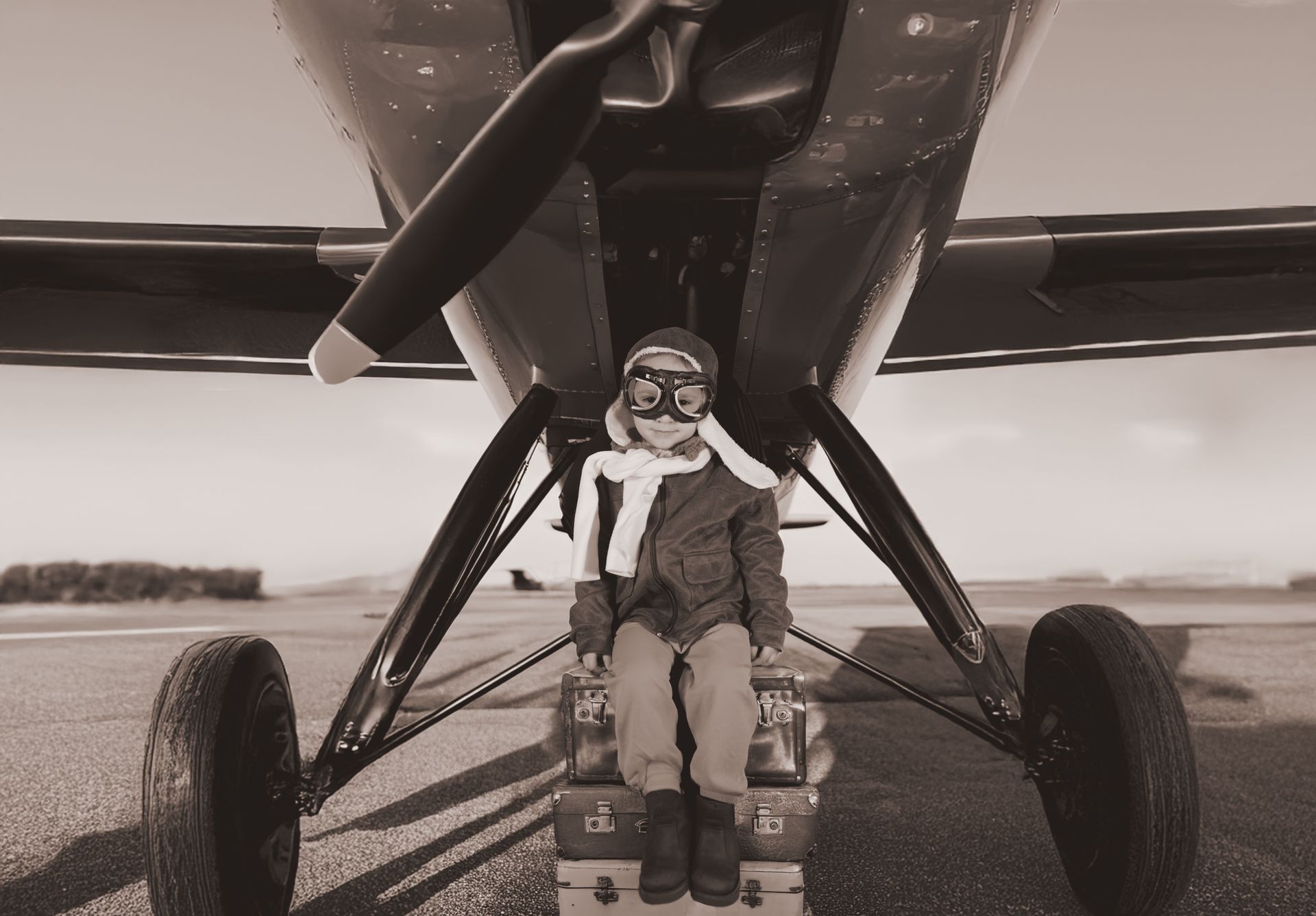 A man is sitting in the cockpit of an airplane