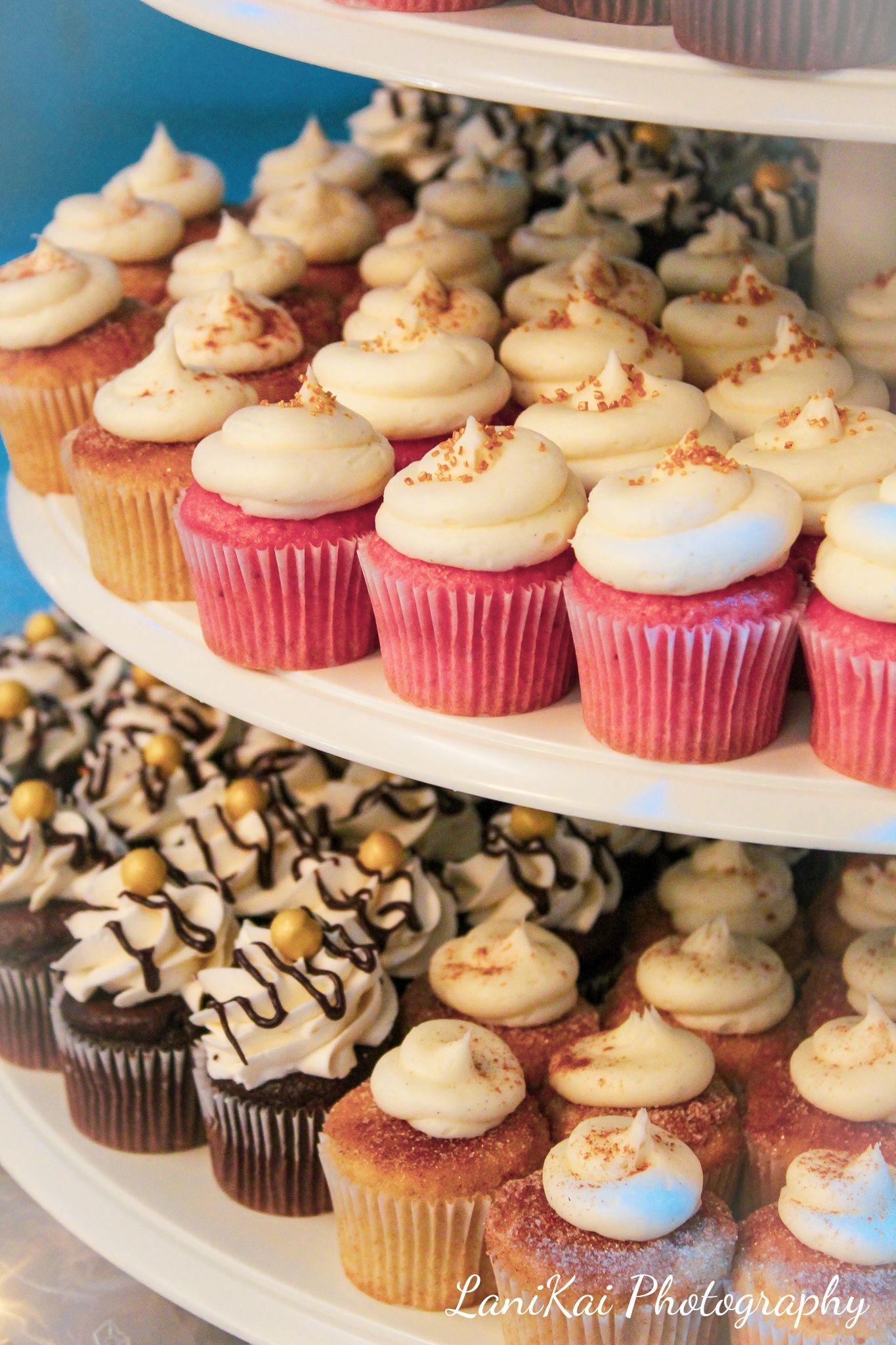 A bunch of cupcakes are stacked on top of each other