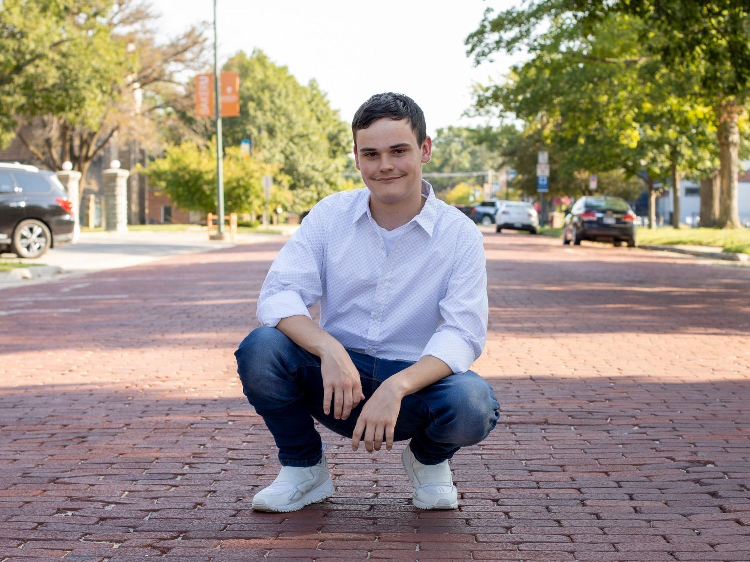 A young man in the middle of the road posing for a photograpy