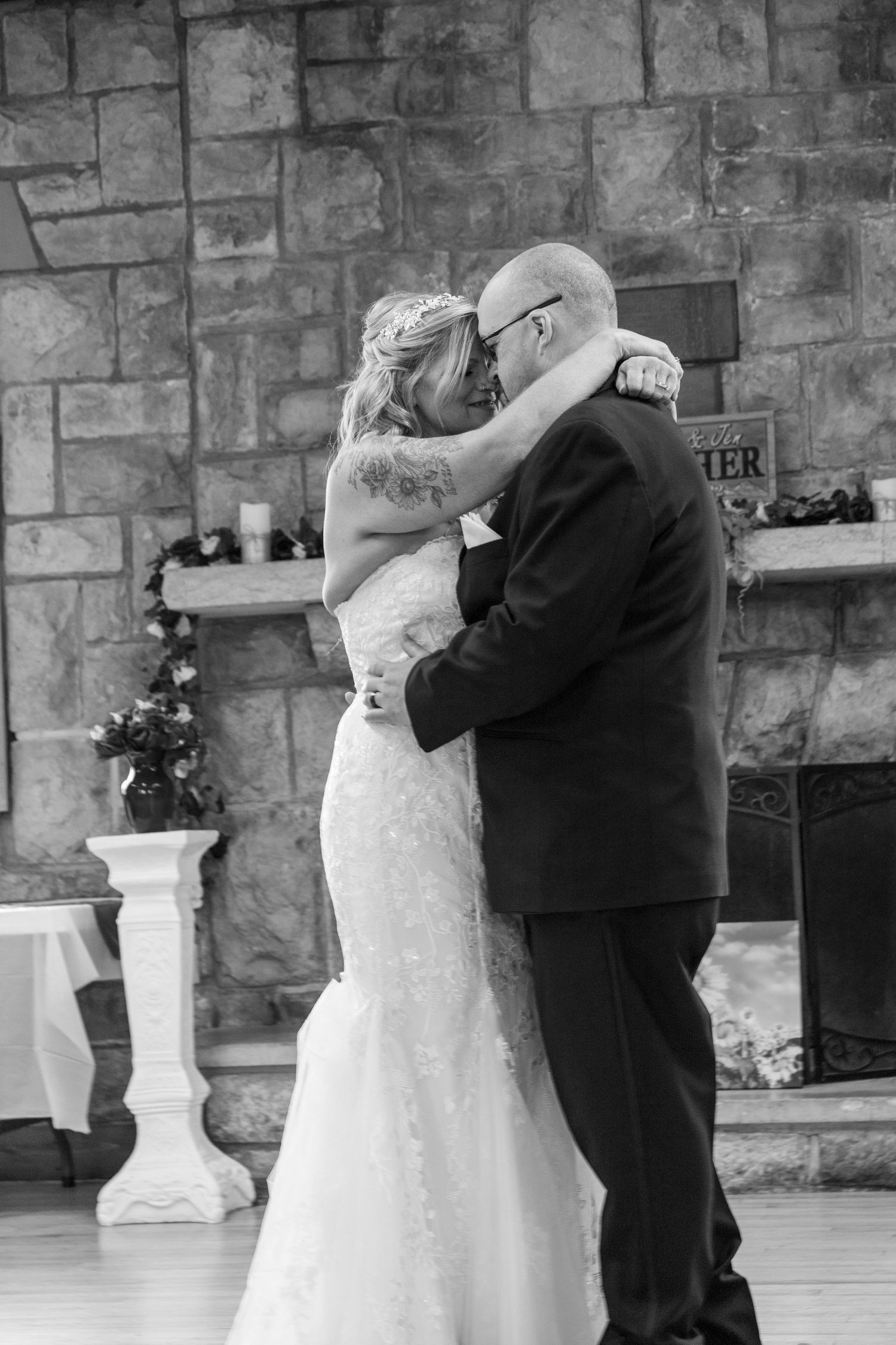 A black and white photo of a bride and groom kissing on their wedding day.
