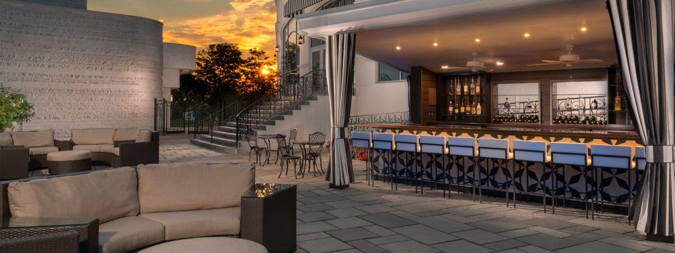 An artist 's impression of a patio area with a bar and a couch.