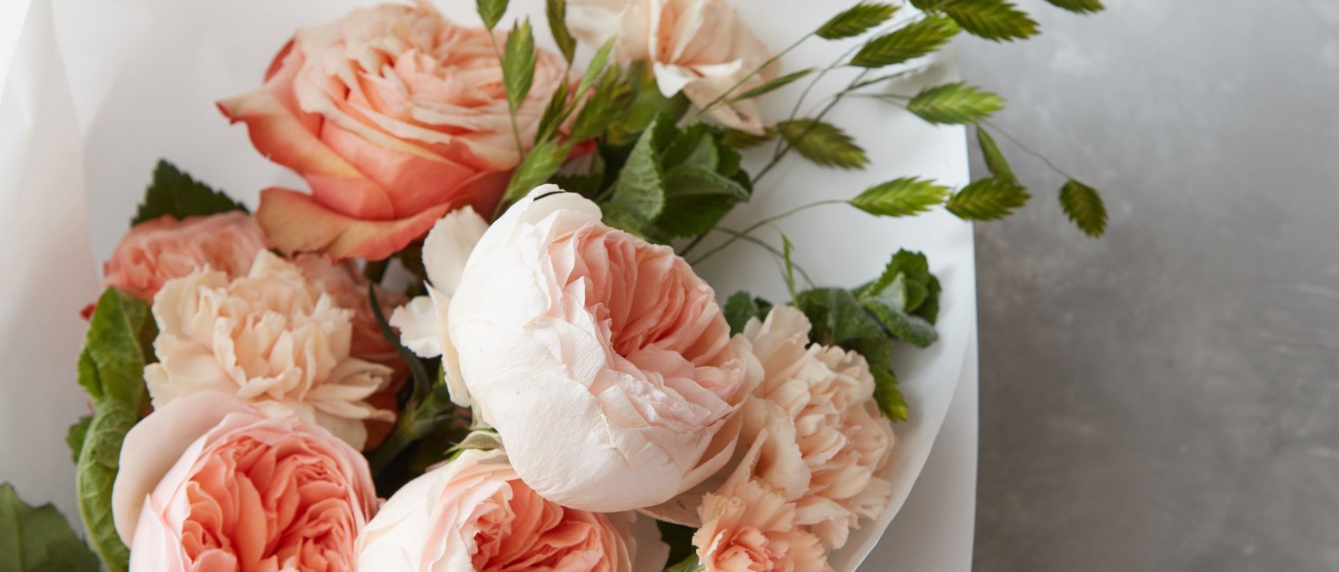 A close up of a bouquet of flowers on a white plate.