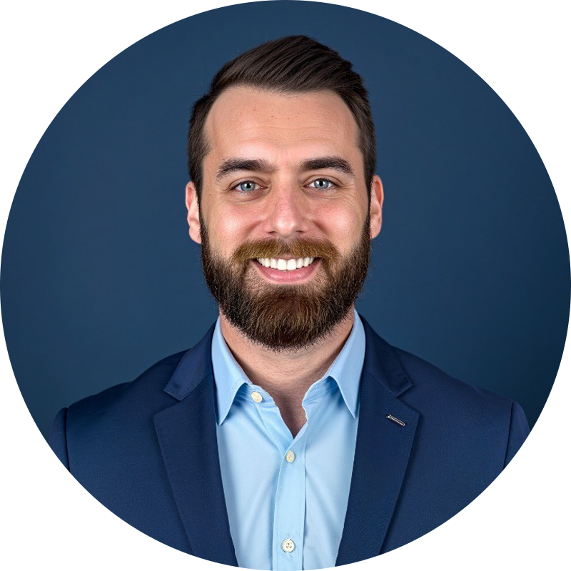 A woman wearing hoop earrings and a black top smiles for the camera