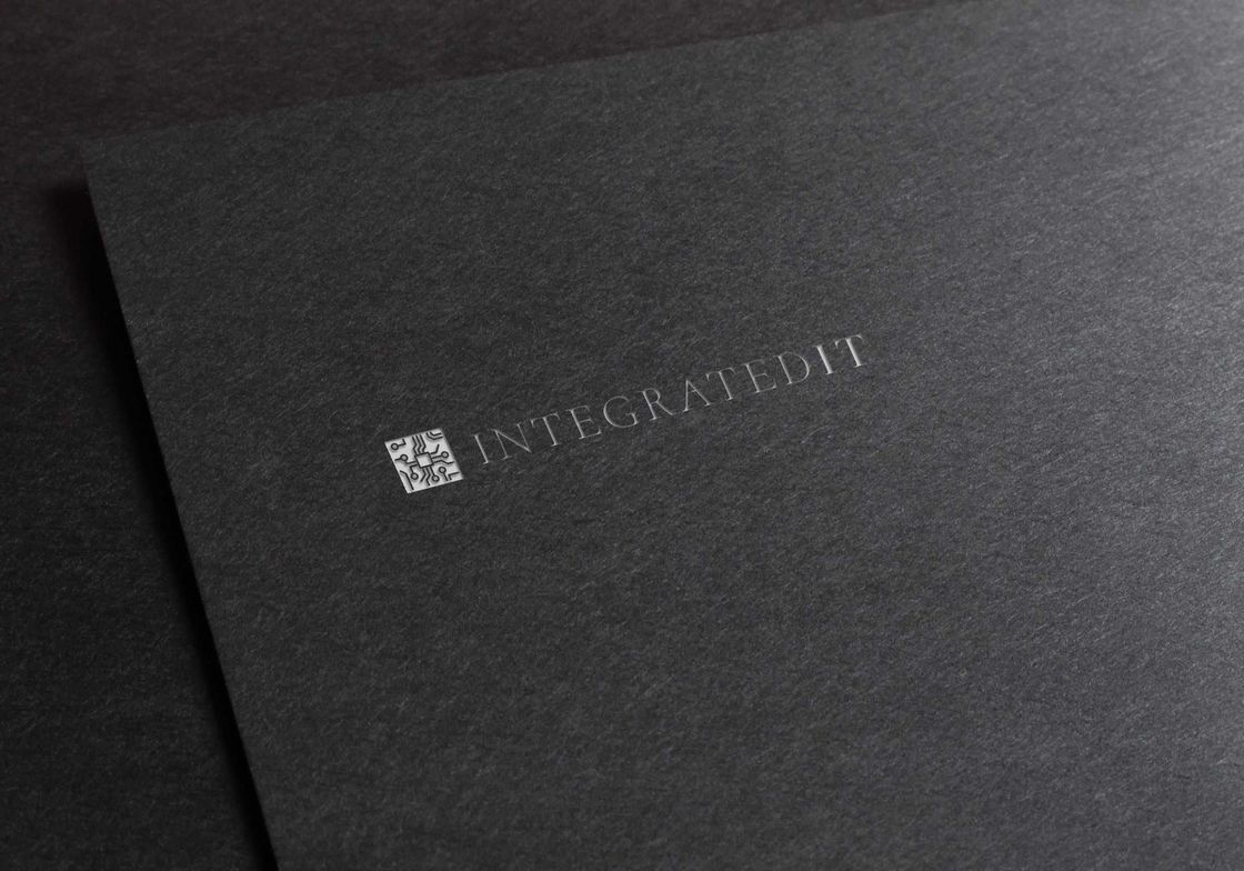 Dark grey textured paper with embossed logo: a square symbol and text 