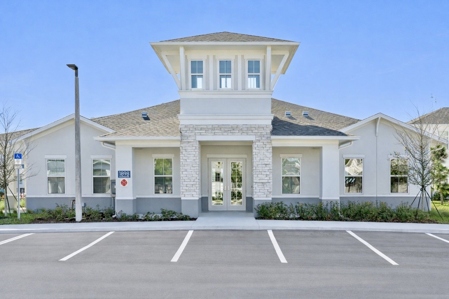 Man holding a child, both smiling, looking at each other. Man wears blue shirt, child wears striped shirt and diaper.