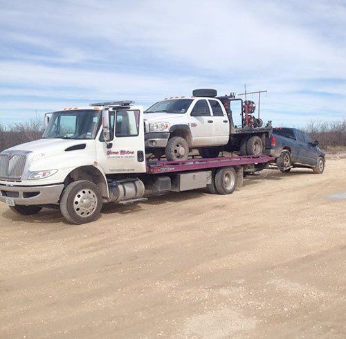 Towing company fleet truck towing multiple vehicles in San Angelo, TX