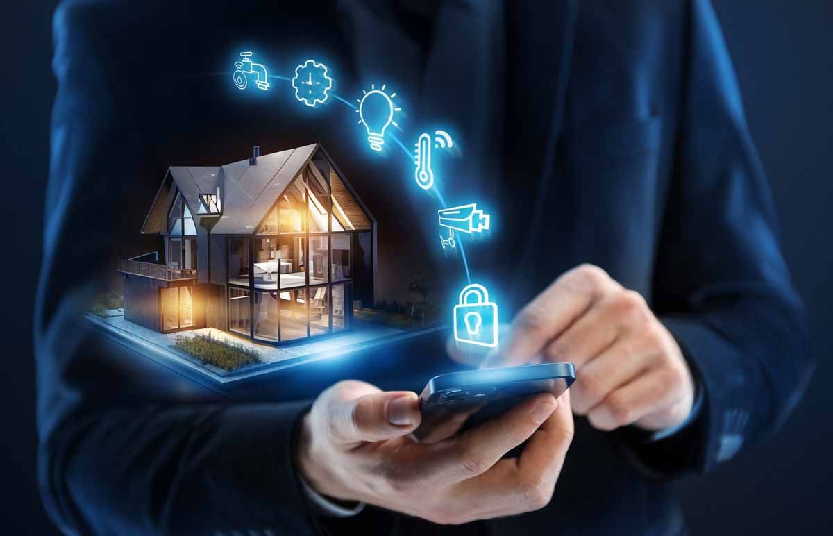 A man is holding a smart phone with a house coming out of it.