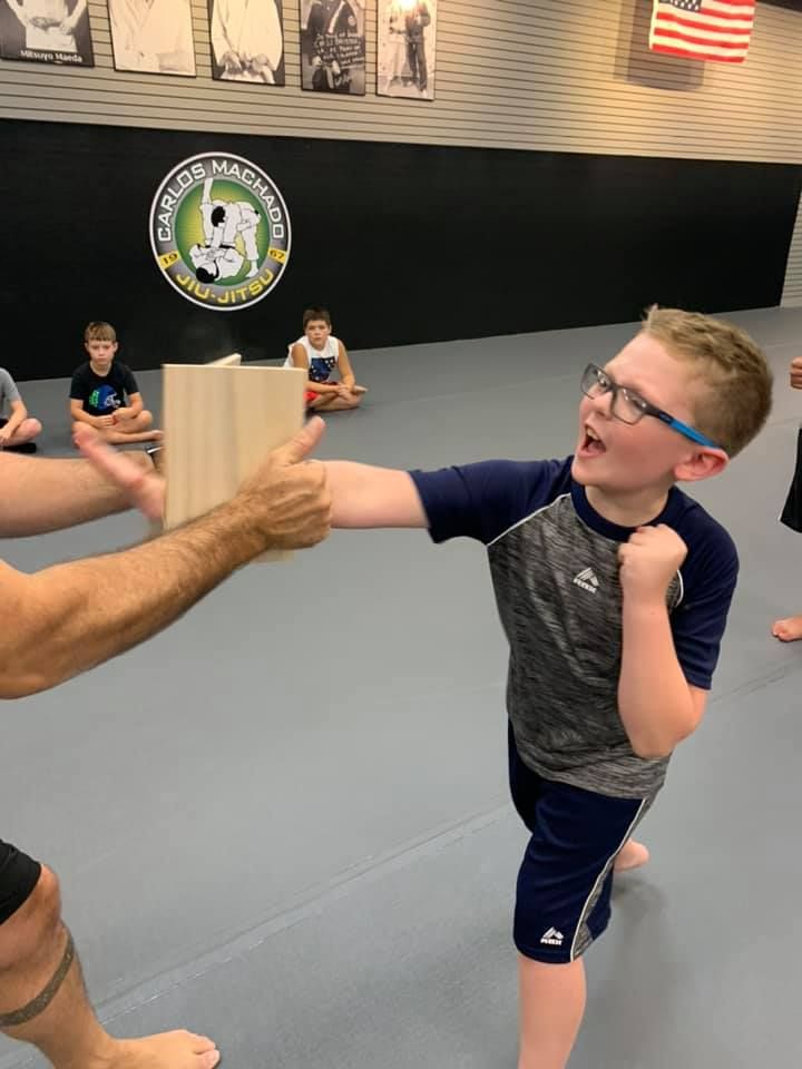 A person is holding a sparkler in their hand in the dark.