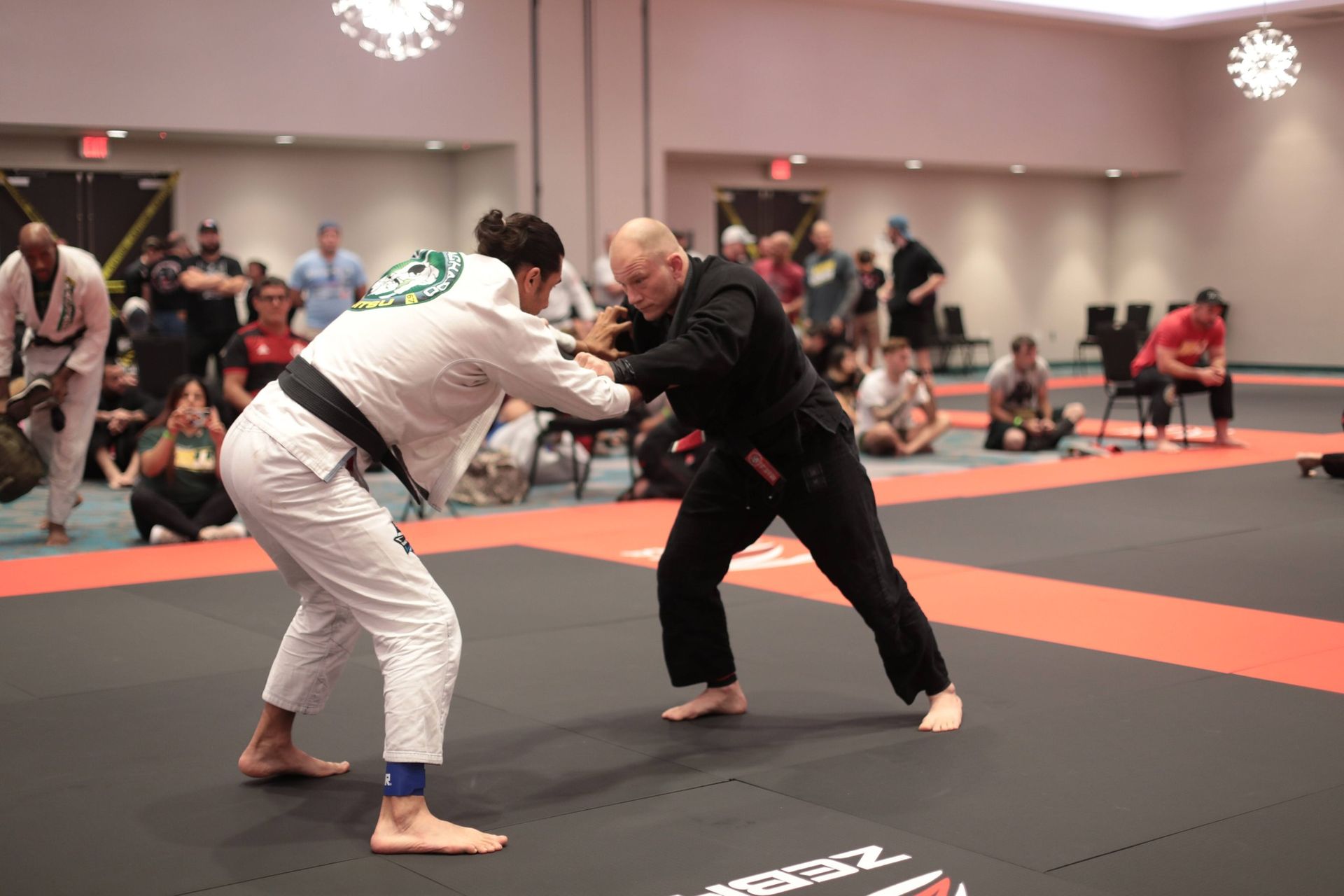 a man and a woman are practicing martial arts on a mat