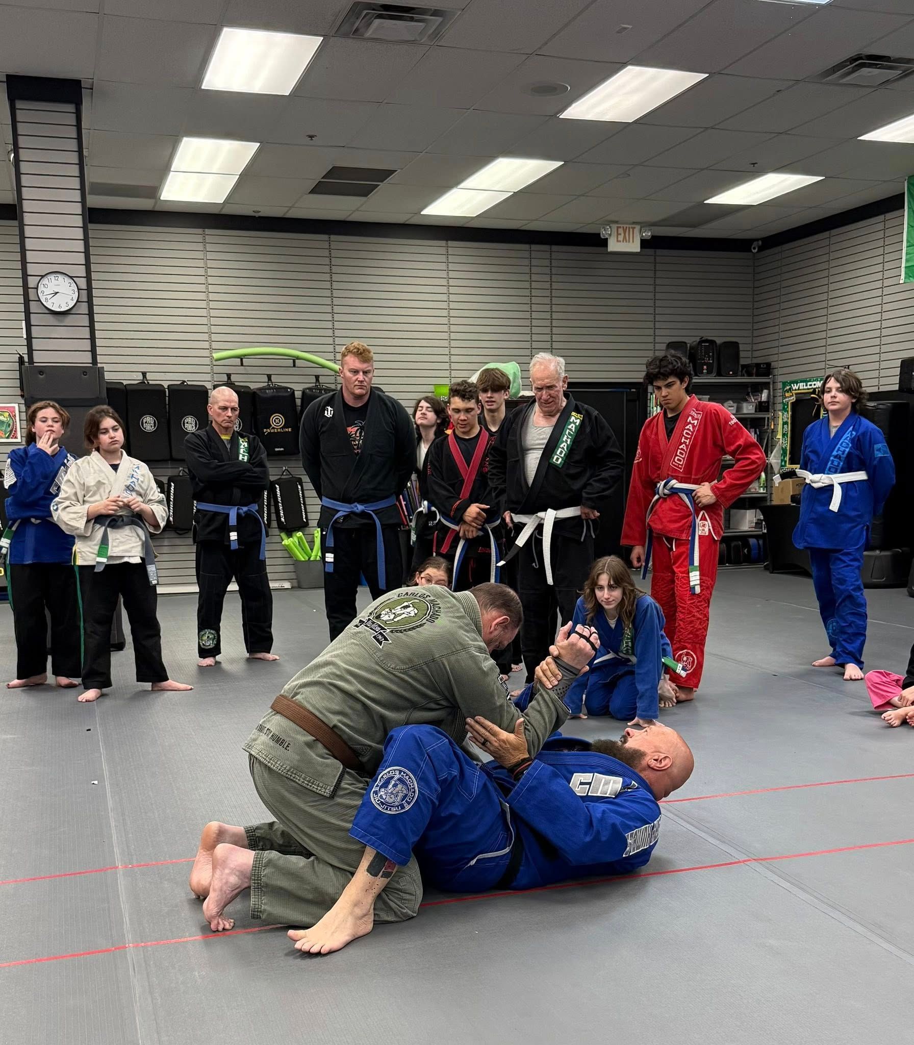 a man is laying on top of another man on a mat