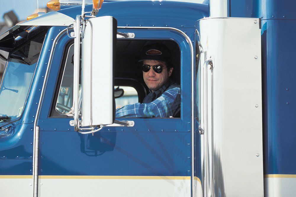 Truck Driver on Blue Truck — Los Angeles County, CA — Commercial Trucking School