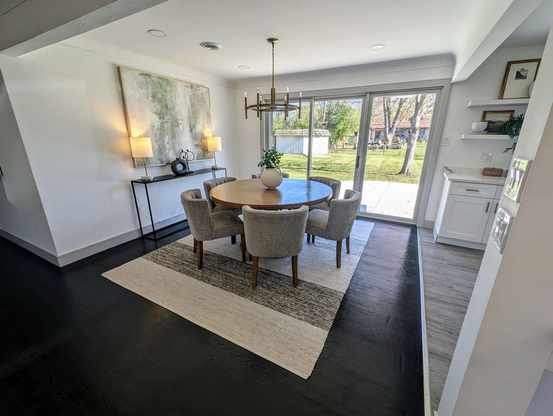 A dining room with a round table and chairs