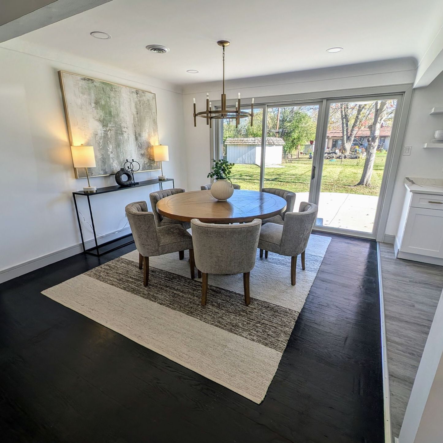 A dining room with a round table and chairs