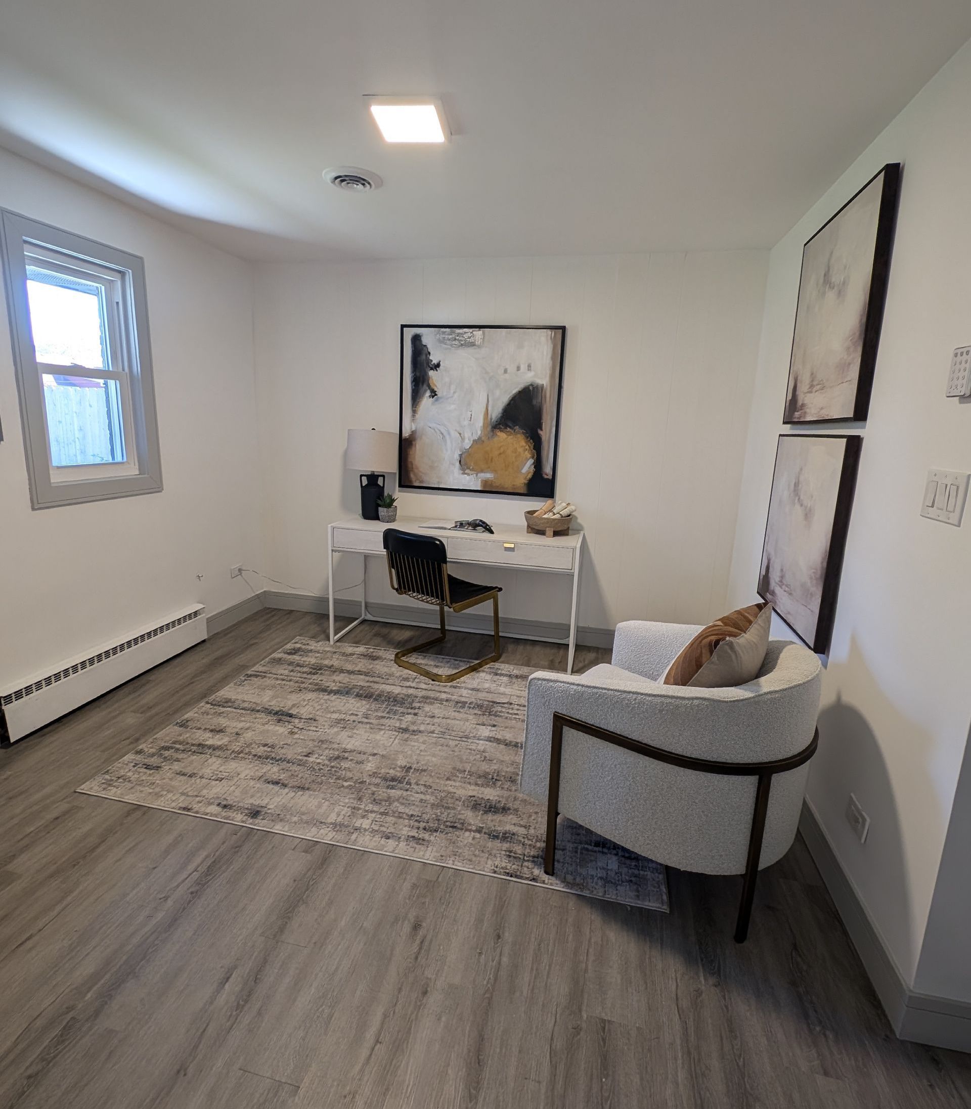 An office with a desk , chair , and rug.