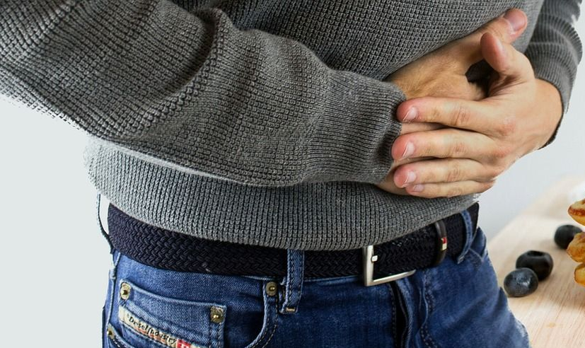 Man holding Central tummy due to pain.