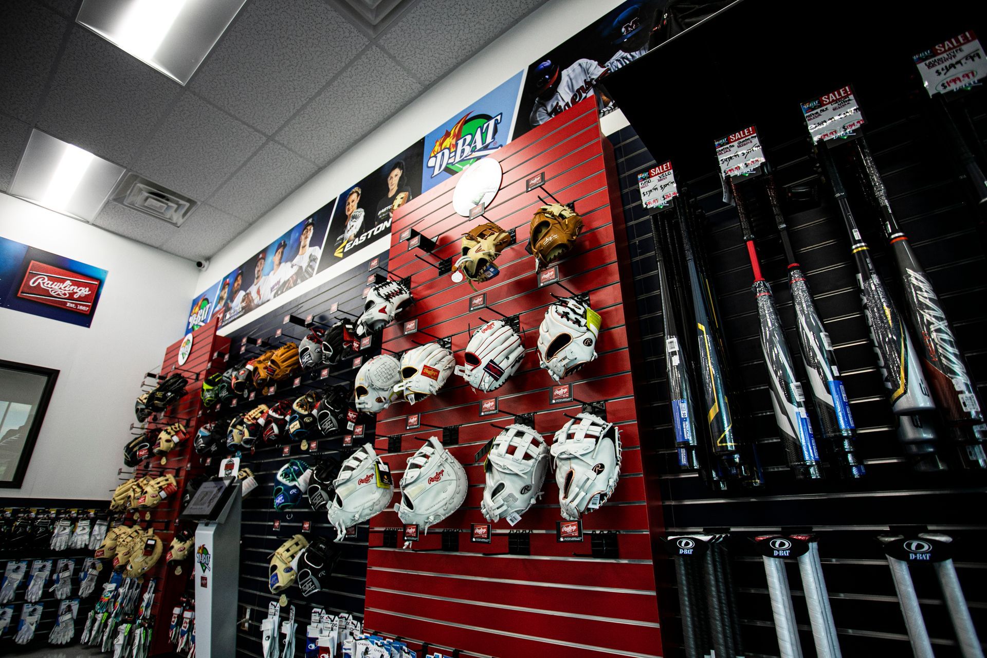 A bunch of hockey masks are hanging on a wall in a store
