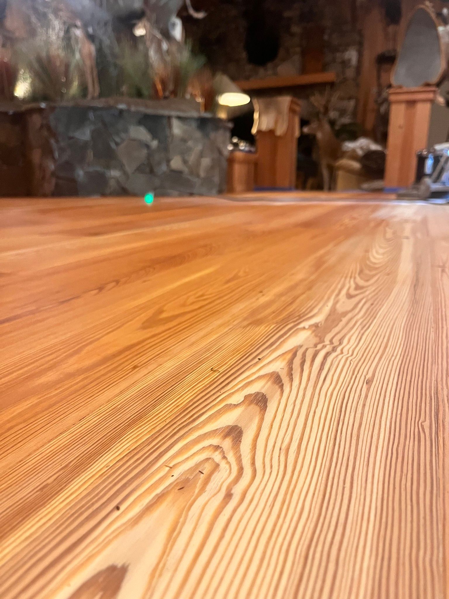 Close-up view of a polished wooden floor with prominent grain patterns.