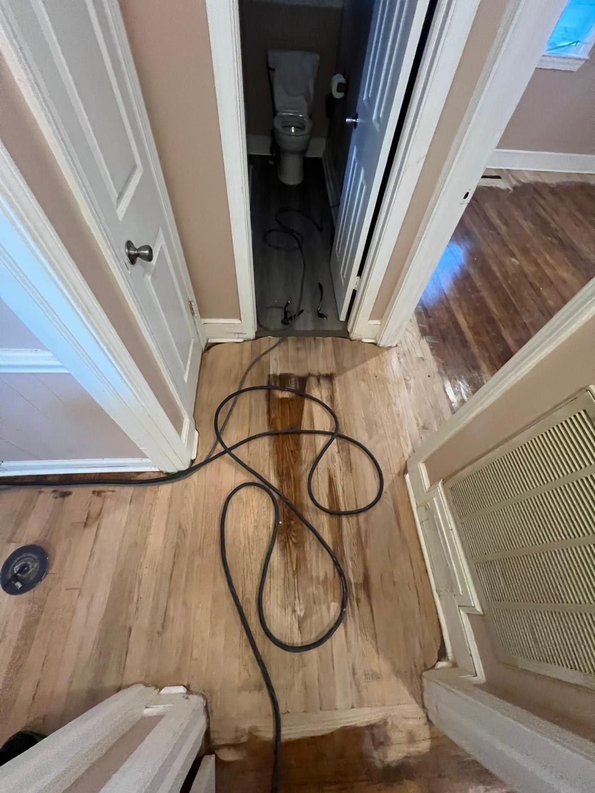 A man is giving a box to a woman in front of a van full of boxes