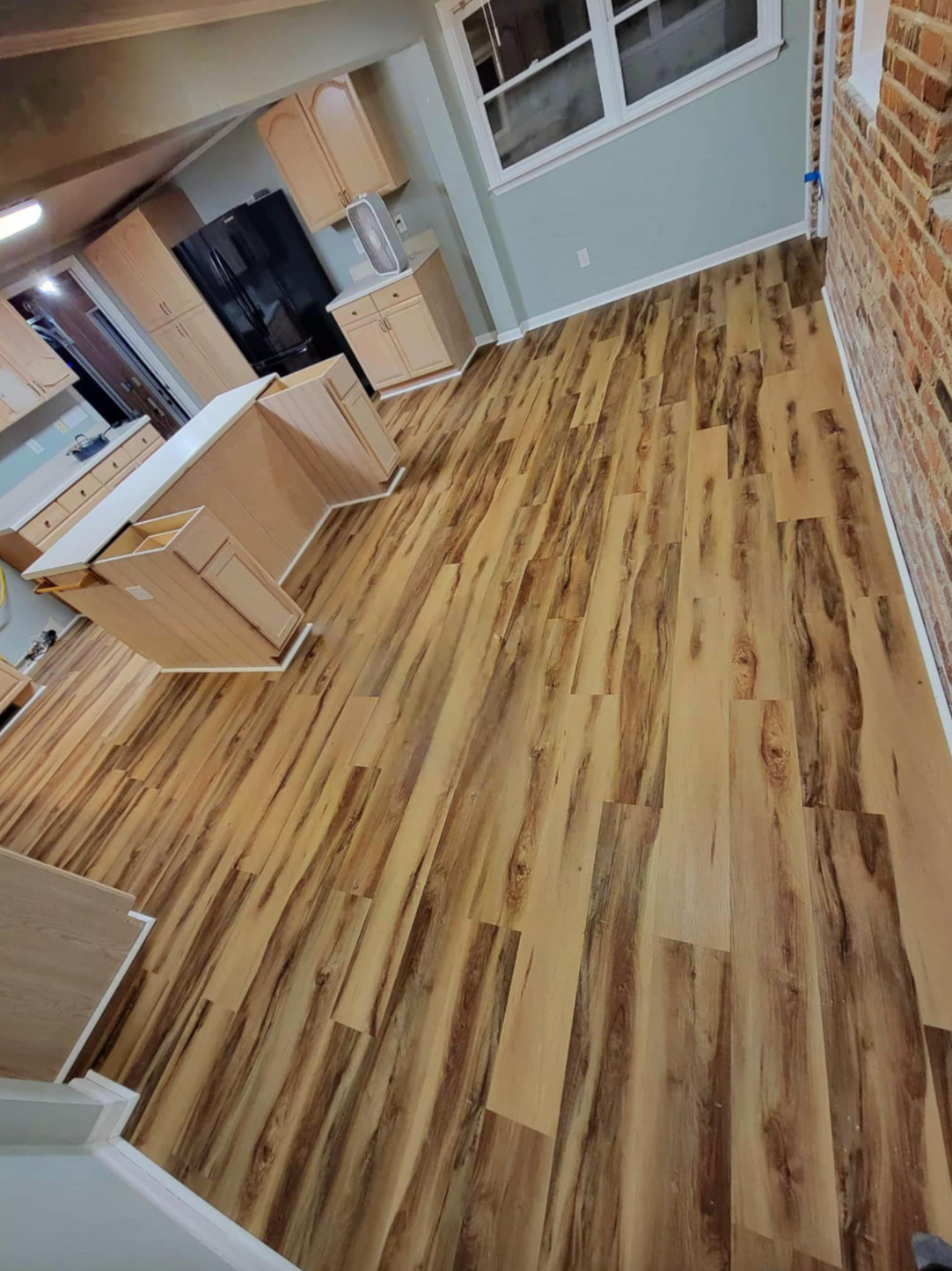 A man wearing a mask is carrying a cardboard box into a van.