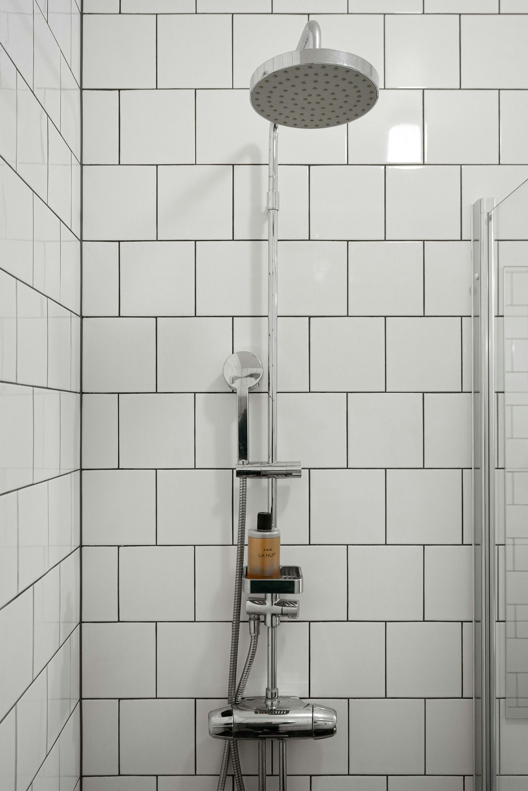 A row of semi trucks are driving down a road