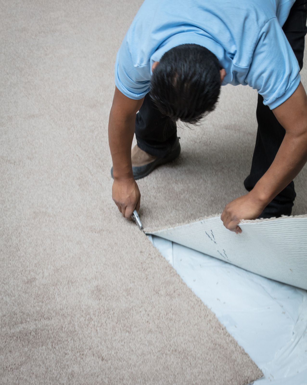 A man wearing a mask is loading boxes into a van