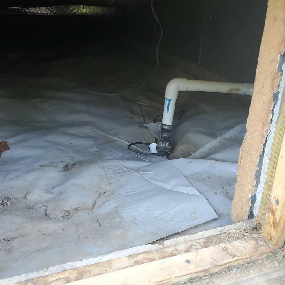 A pipe is connected to a drain in a basement.