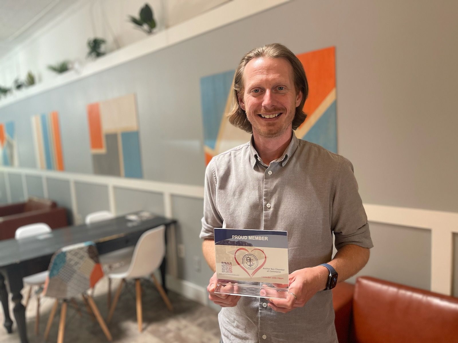 A man is holding a card with a heart on it.