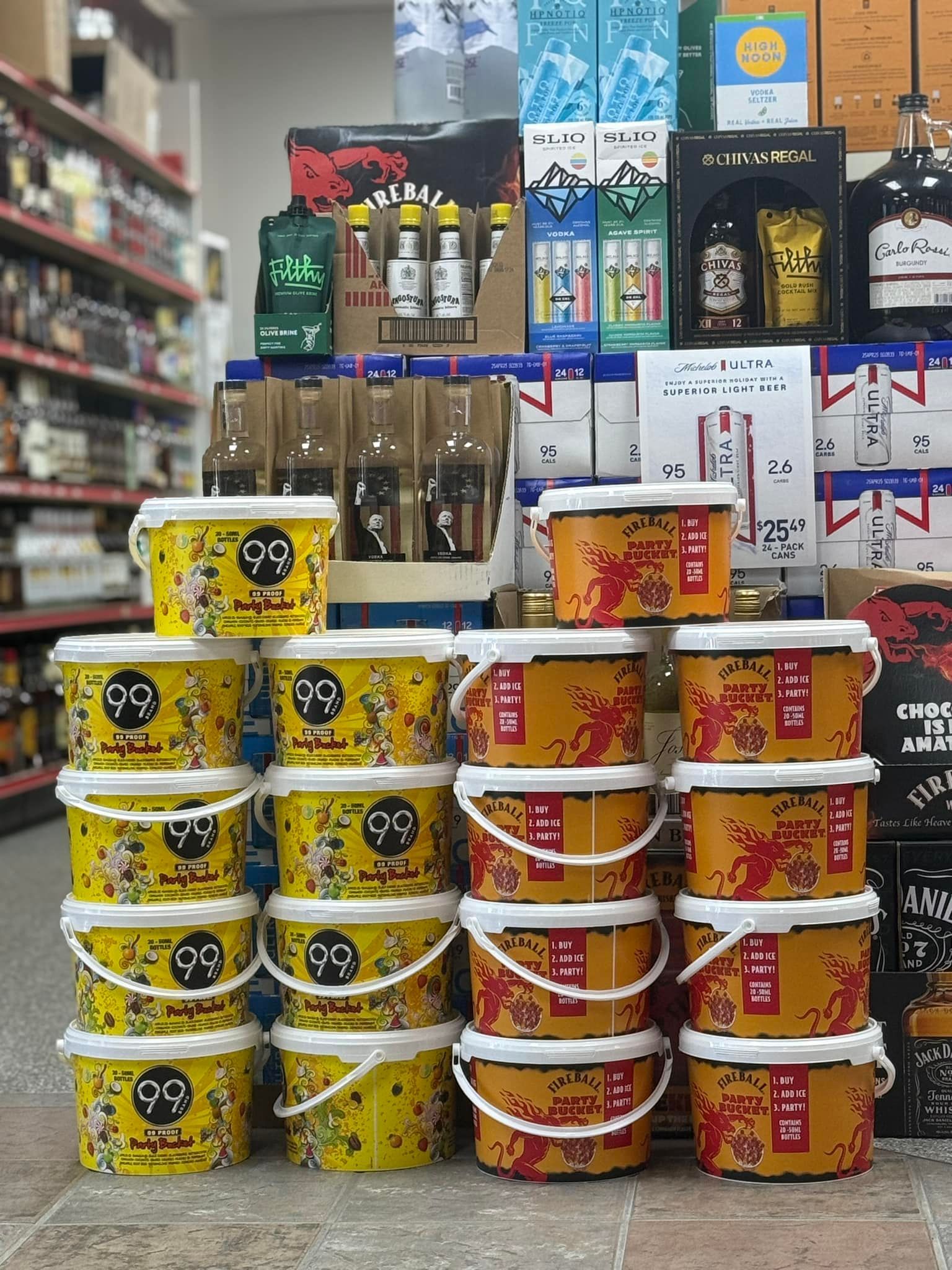 A bunch of buckets are stacked on top of each other in a store.
