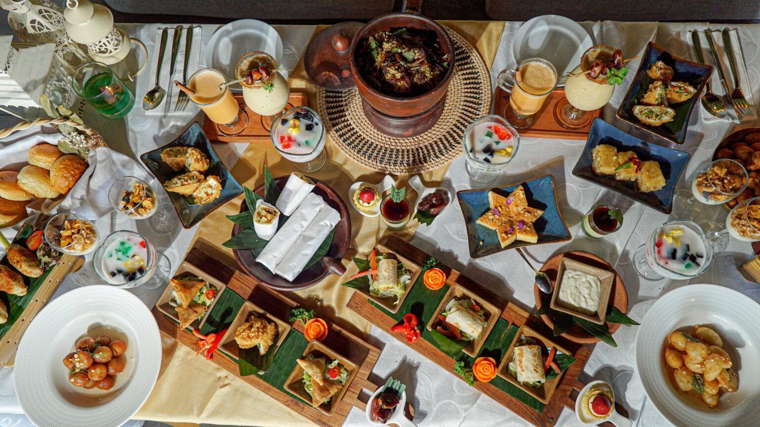 A table topped with plates of food and drinks.