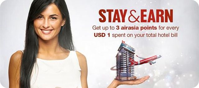 A woman is holding a model of a building in her hand.