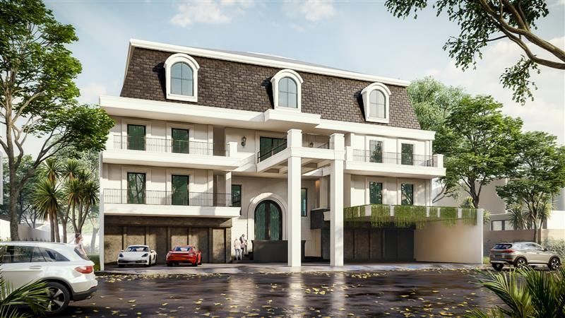 Three-story building with a dormer roof and a car park. The building has white and brown tones with some greenery around it.