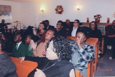A group of men are singing into microphones in a church.