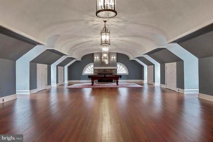 There is a pool table in the middle of the room.