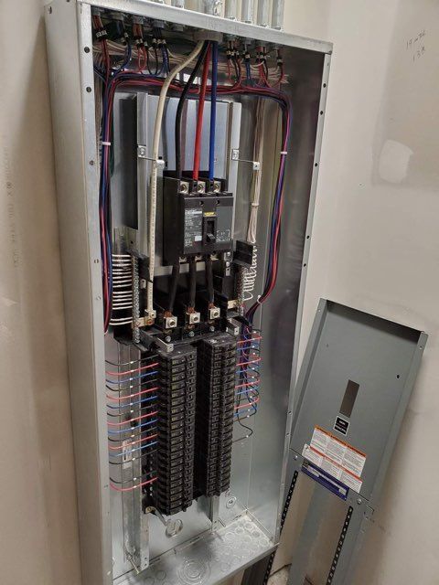 A large electrical box with a lot of wires coming out of it.