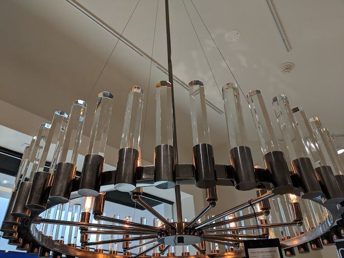 A large chandelier with clear glass tubes hanging from the ceiling
