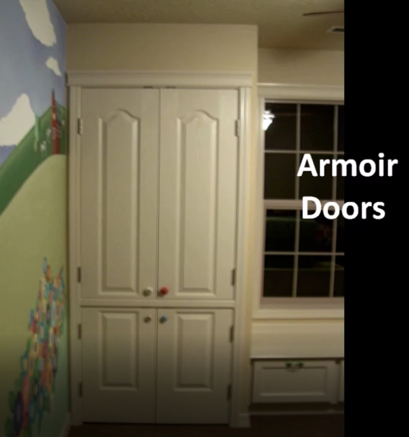 White armoir doors next to a window in a room with a mural.
