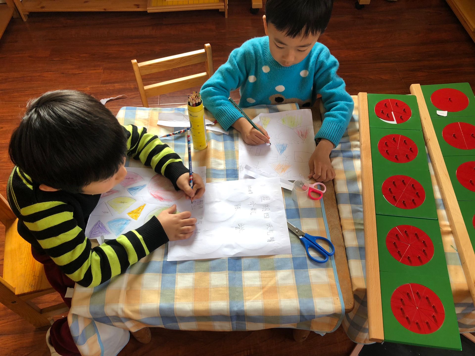 Two Montessori child working in the classroom