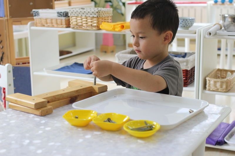 Montessori child working with Montessori materials in the classroom