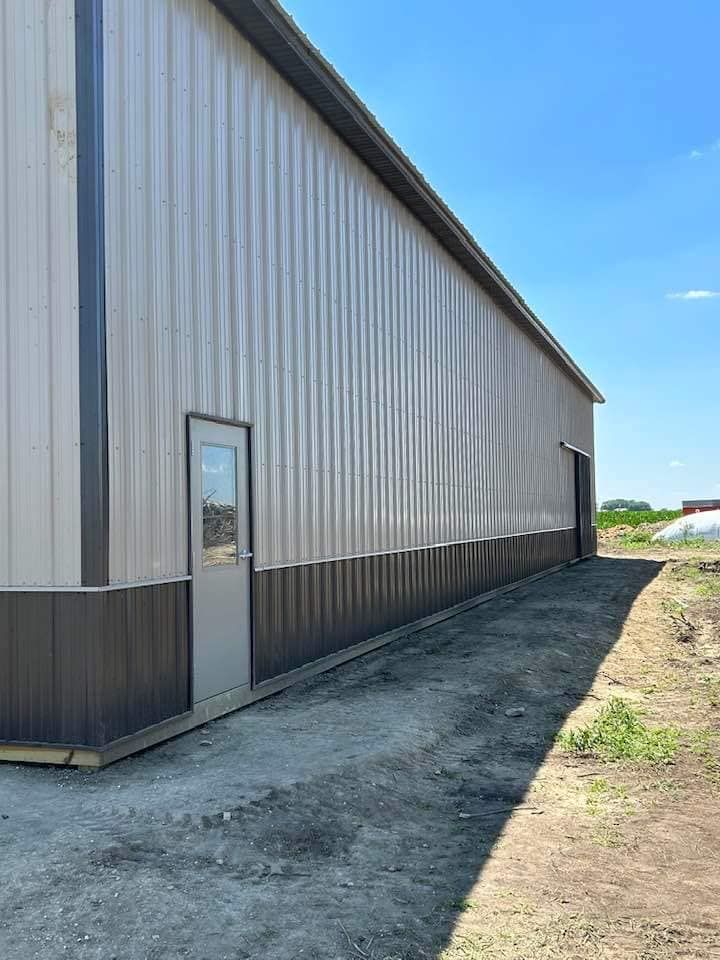 A large metal building with a door on the side of it.