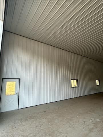 A large empty building with a door and windows.
