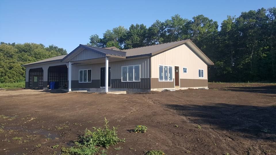 A house is being built in the middle of a dirt field