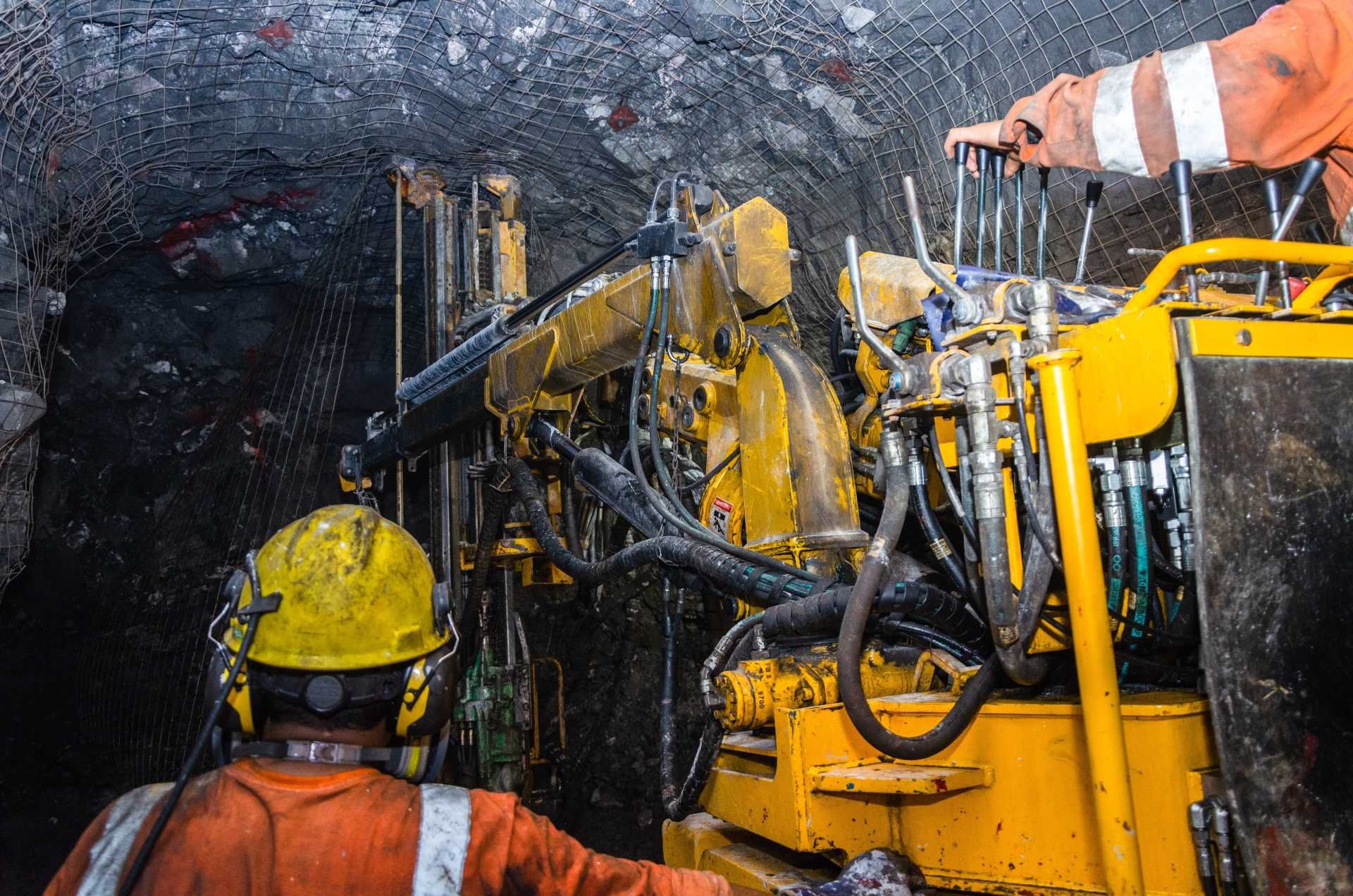 A man is operating a machine in a mine.