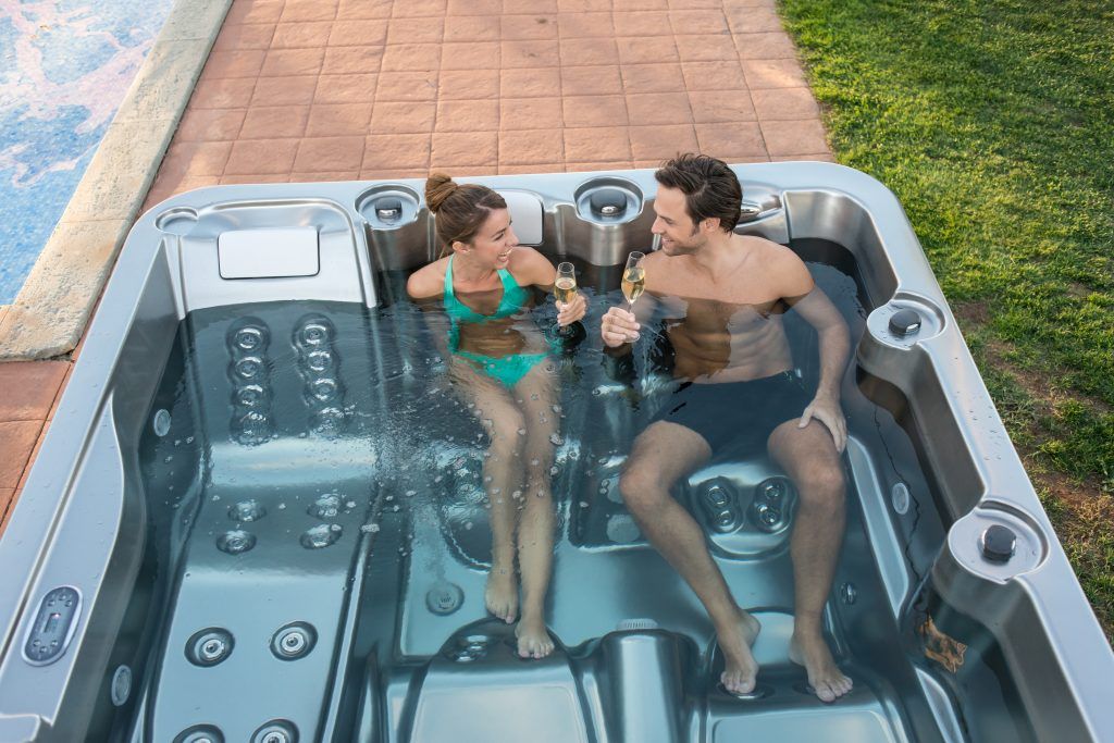 man and women enjoying a hypa spa hot tub