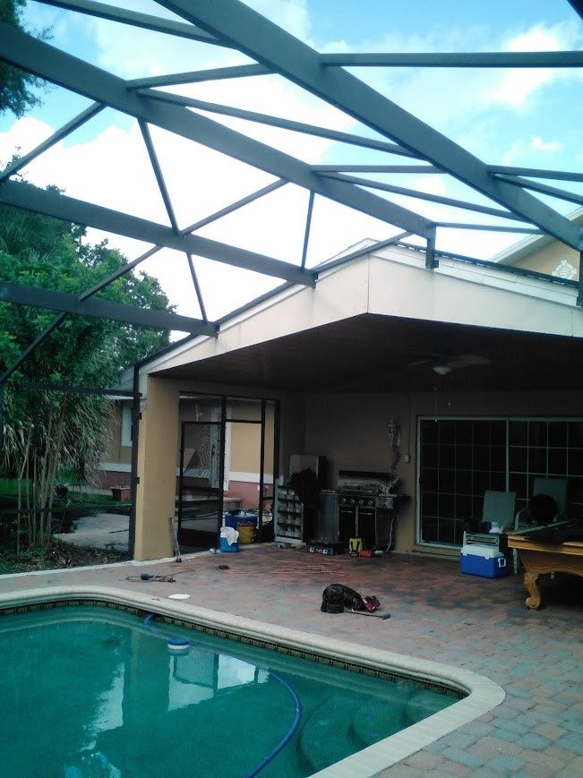 A large metal structure is being built in front of a house