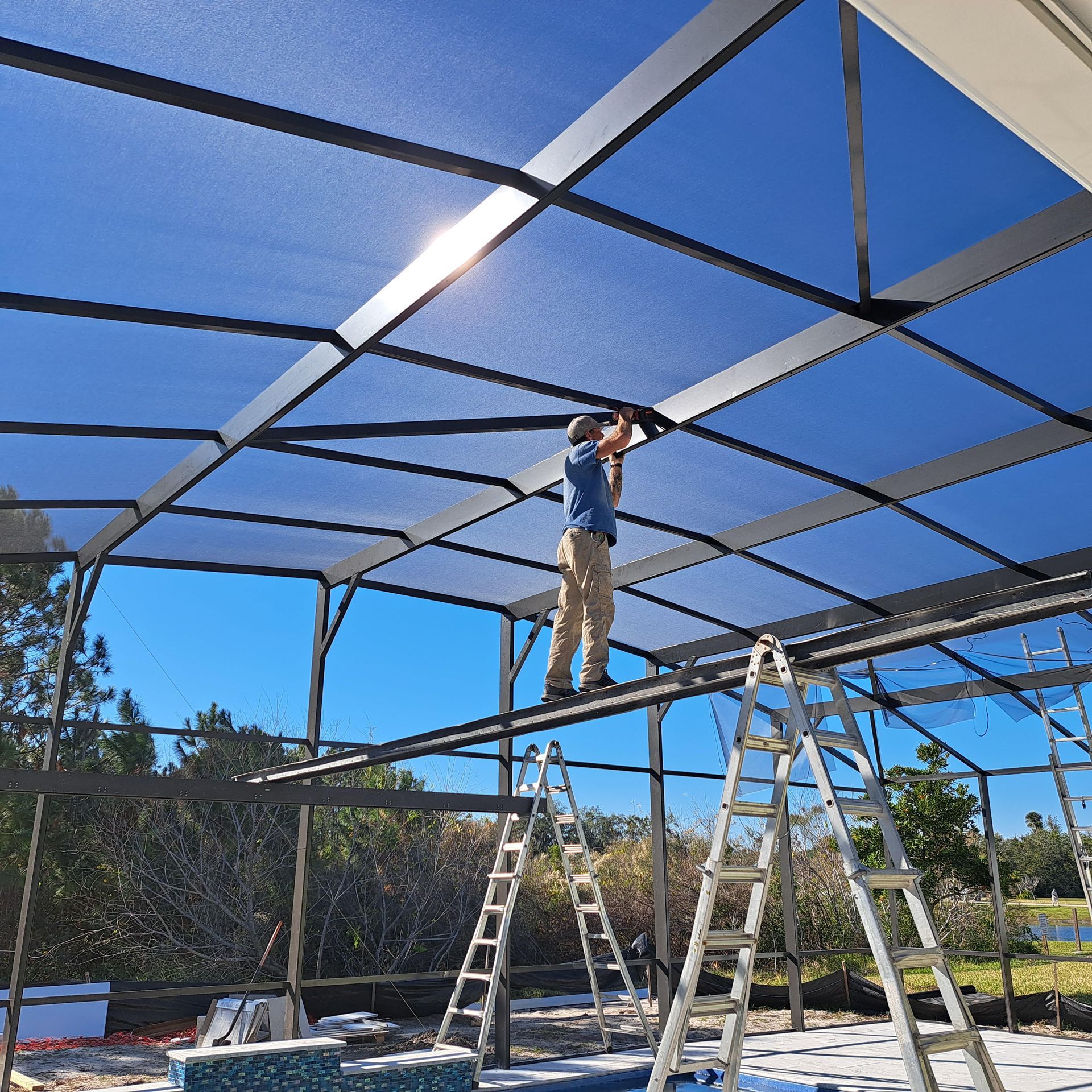 A man on a ladder working on a roof
