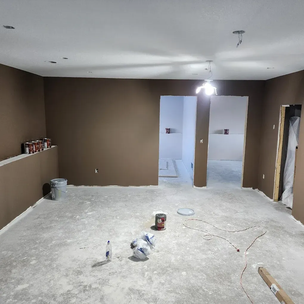 An empty room with brown walls and a light on the ceiling